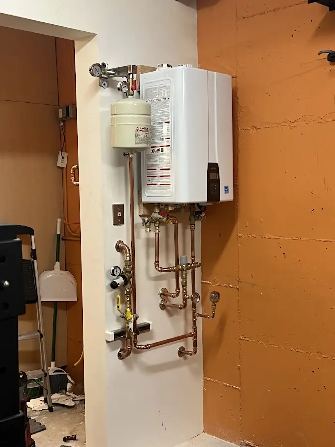 Plumbing technician inspecting water heater connections in Metropolis